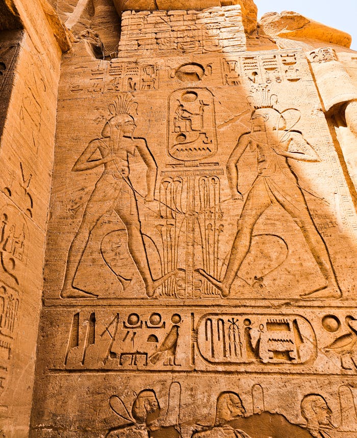Abou Simbel Detailed hieroglyphs and carvings on an ancient Egyptian temple wall, showcasing historical art and architecture.