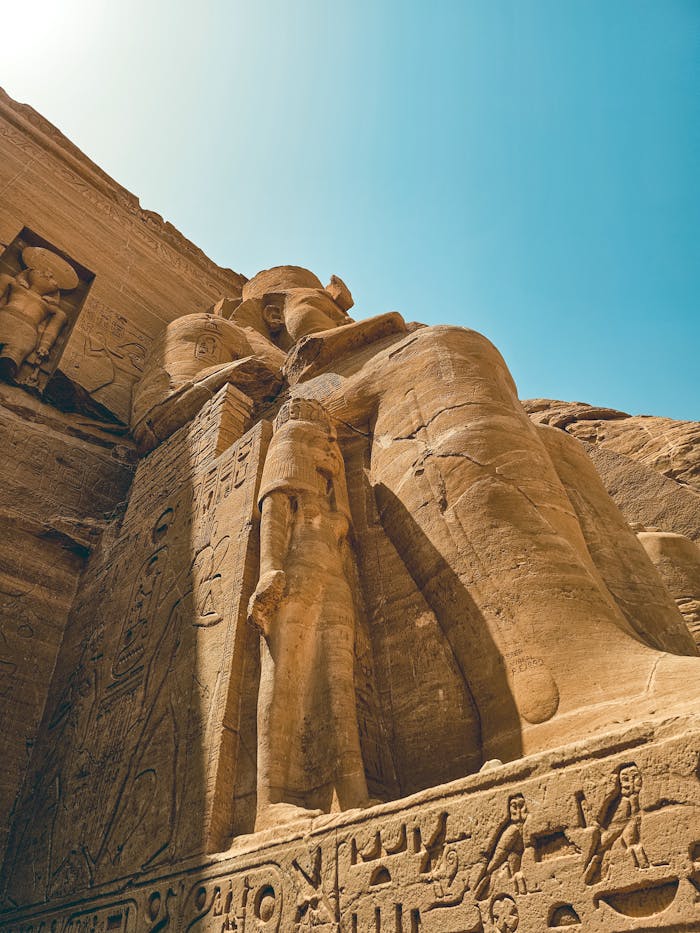 Abou Simbel Impressive view of the colossal statues at Abu Simbel in Egypt under a clear blue sky.